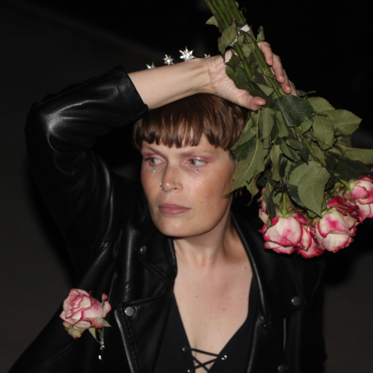 Tennell holding bouquet next to her head.